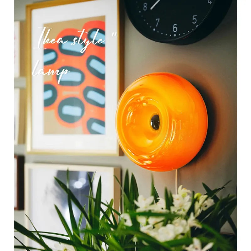 Ornate vintage French table lamp with a warm yellow glass shade and a decorative metal base on a WALL.