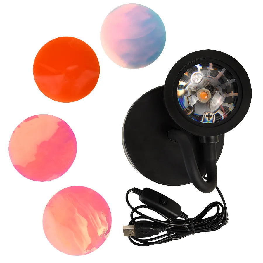 Compact, black USB-powered sunset projector lamp with an adjustable head, casting a mesmerizing blend of red, orange, and pink hues onto a bedroom ceiling.