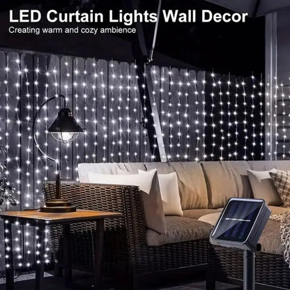 SolarCurtain™ Waterproof LED Fairy Lights illuminating a beautiful outdoor garden space with a warm, enchanting glow, showcasing their durable and versatile design perfect for both indoor and outdoor festive decorations.