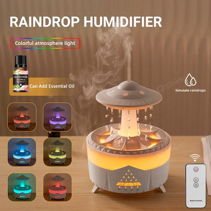 A white Ndotohuis 3-in-1 Rain Cloud Diffuser in the shape of a cloud, emitting cool mist and featuring a glowing rain cloud design.