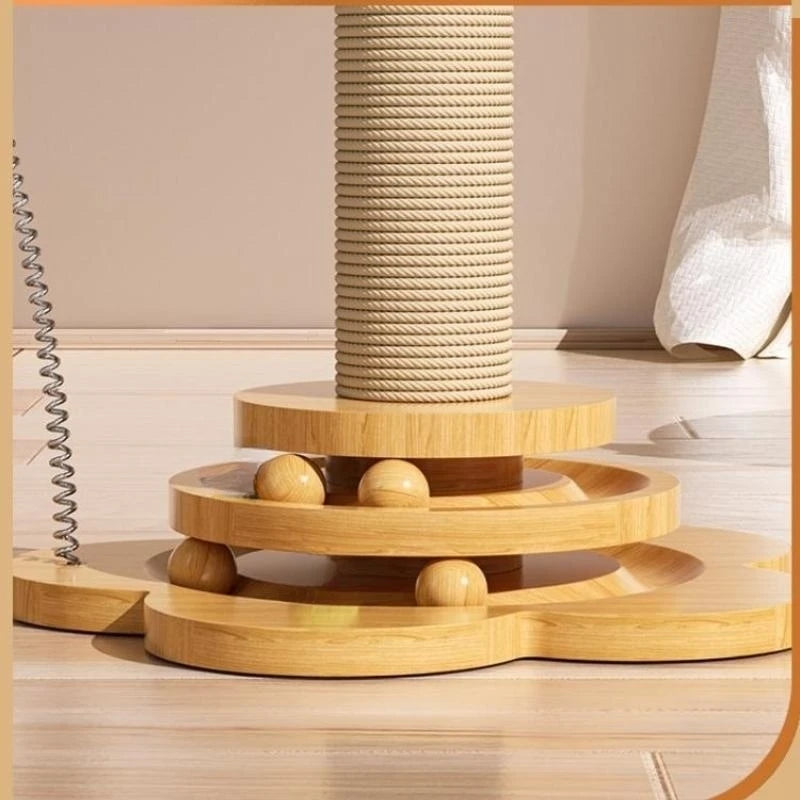 A beige Ndotohuis Kitty Clubhouse with a sisal scratching post in the center, a spinning turntable with colorful balls on top, and a sleek wooden base.