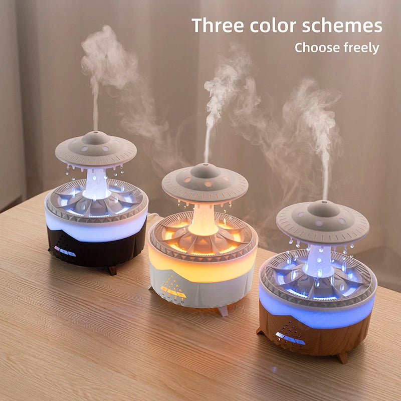 A white Ndotohuis 3-in-1 Rain Cloud Diffuser in the shape of a cloud, emitting cool mist and featuring a glowing rain cloud design.