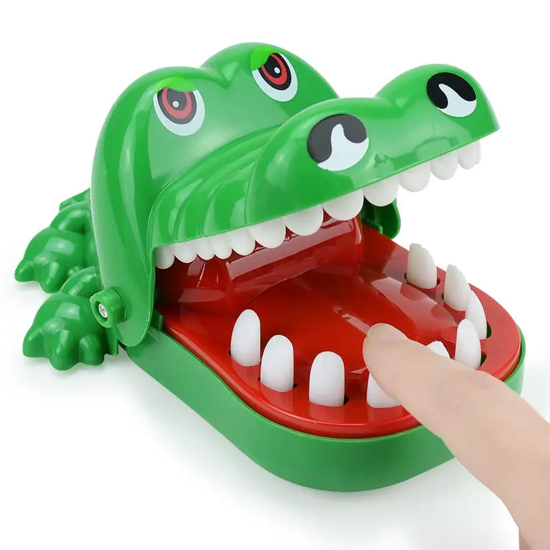 A green toy alligator with large teeth, open wide as if ready to snap.