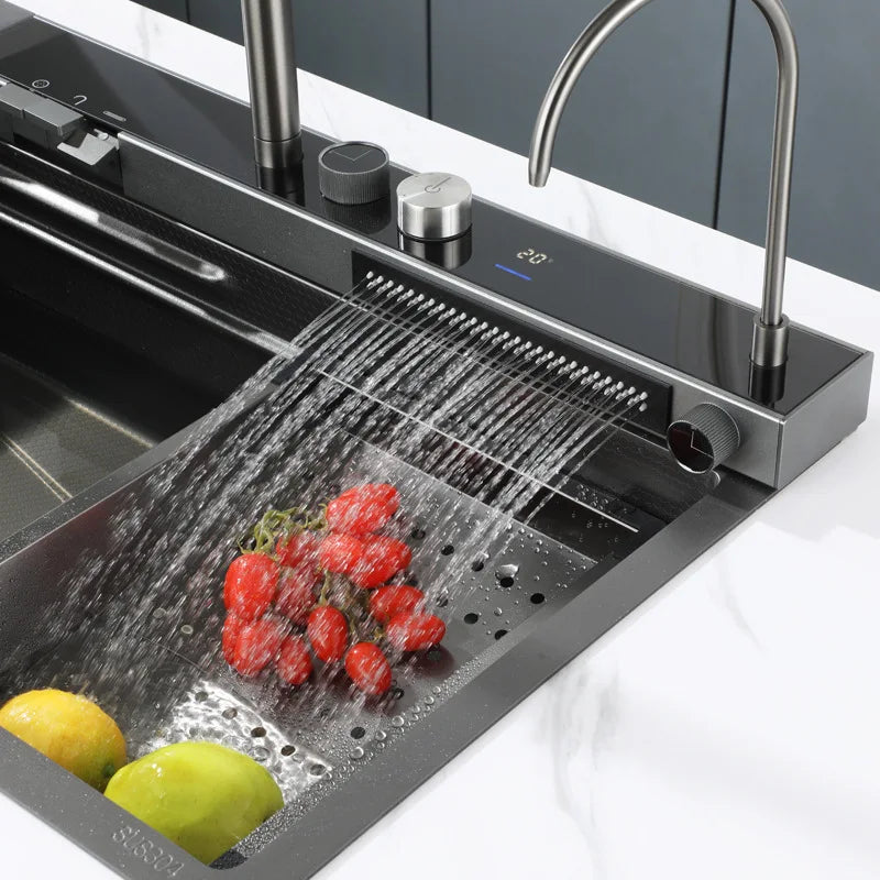 Black stainless steel kitchen sink with waterfall faucet and digital display mounted on a countertop.