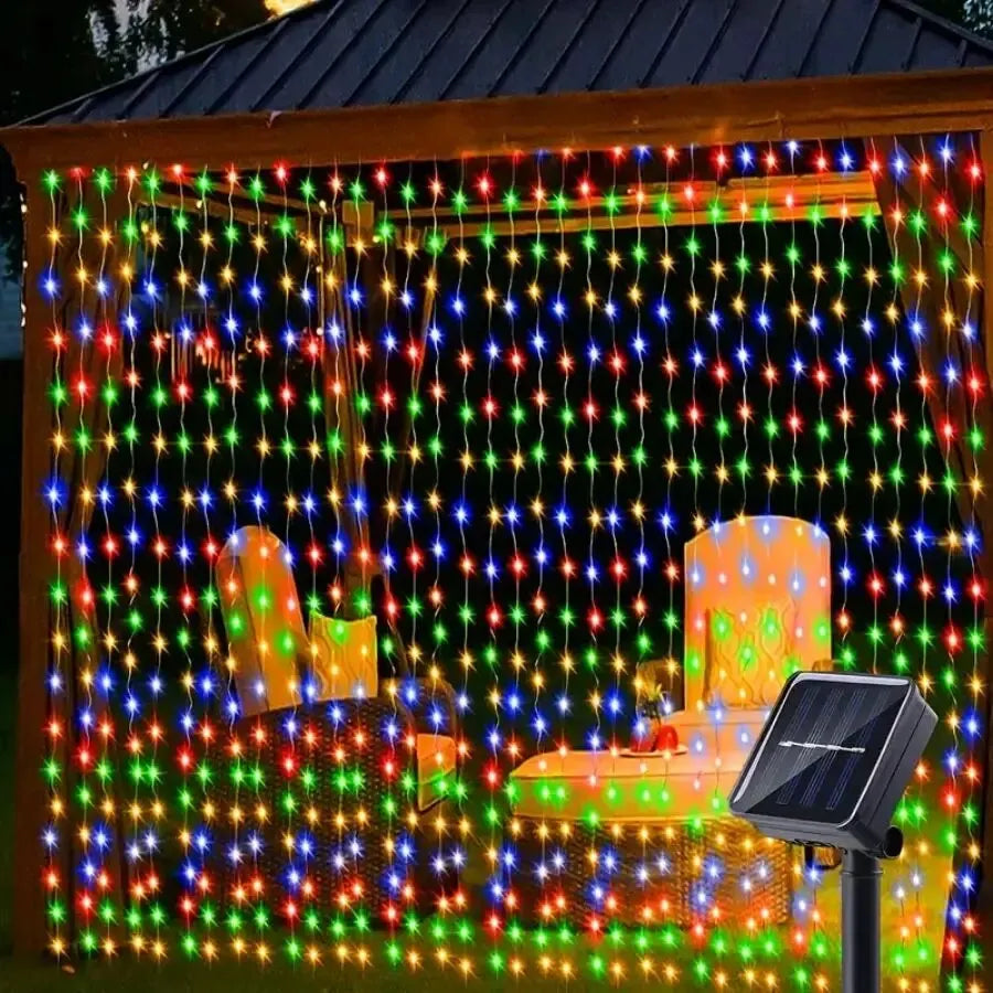 SolarCurtain™ Waterproof LED Fairy Lights illuminating a beautiful outdoor garden space with a warm, enchanting glow, showcasing their durable and versatile design perfect for both indoor and outdoor festive decorations.