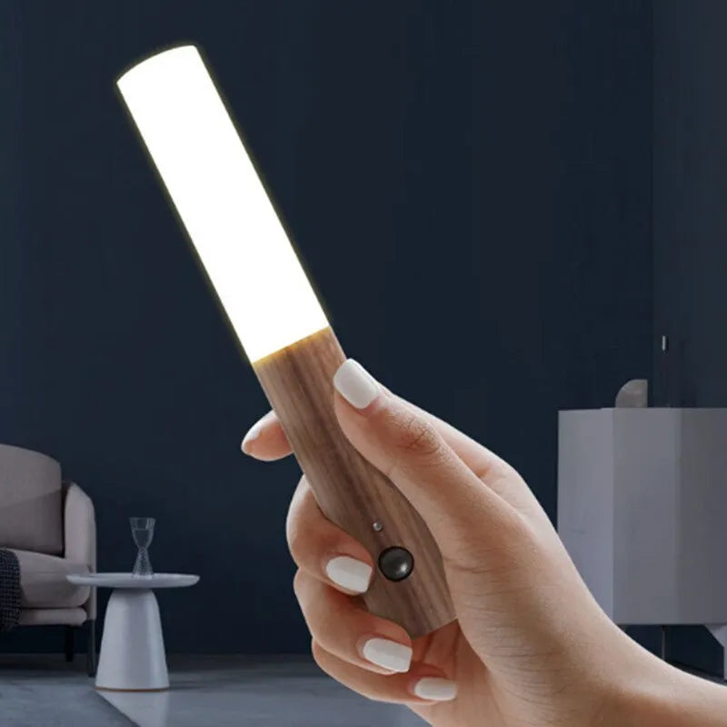 GlowMotion™ Portable LED Night Light with motion sensor and magnetic base, illuminated in a hallway.