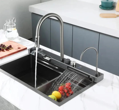 Black stainless steel kitchen sink with waterfall faucet and digital display mounted on a countertop.